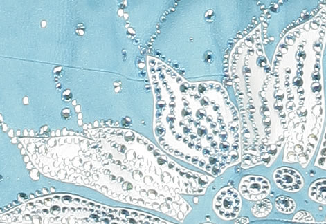 close-up of white pearlized lambskin applique